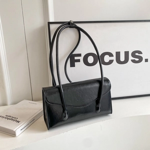 Minimalist black crinkle patent leather shoulder bag with sleek long dual handles