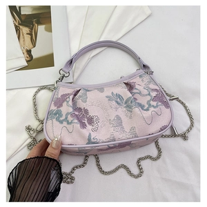 Detail of lavender embroidery handbag with floral jacquard and silver chain strap