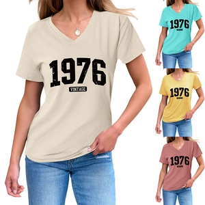Detail view of V-neck short sleeve T-shirt showing retro 1976 print and color options