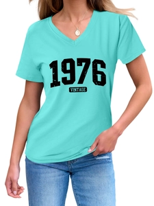 Detailed V-neckline of mint green vintage 1976 t-shirt with distressed black lettering