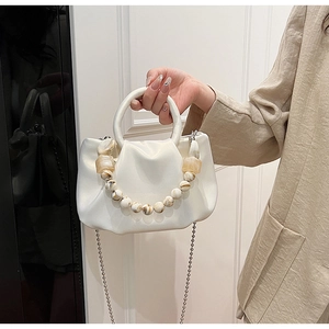 Détail du sac nuage plissé blanc avec fini brillant et chaîne en perles marbrées
