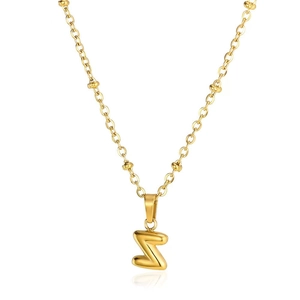 Detail of a 3D puffed golden letter Z pendant with stylish gold bead chain