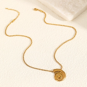 Detailed view of the gold seashell spiral pendant with textured rope chain craftsmanship