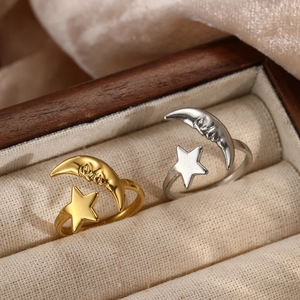 Adjustable stainless steel open ring featuring vintage gold and silver moon and star designs