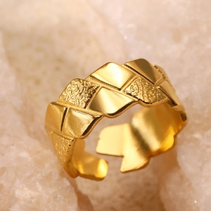 Macro view of gold 18k pleated geometric ring with adjustable opening and textures