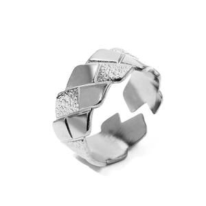 Macro shot of silver quilted geometric ring with polished and hammered texture