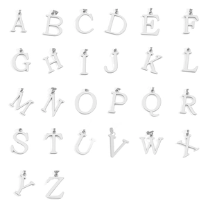 Macro view of polished stainless steel A-Z letter pendants for layered necklaces