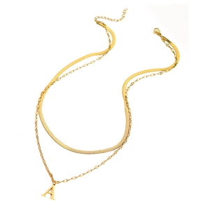 Macro detail of golden double-layer necklace featuring a flat herringbone chain and letter A pendant