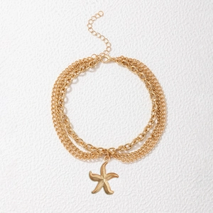 Gold-tone multilayer beach anklet featuring a textured starfish pendant and layered chains