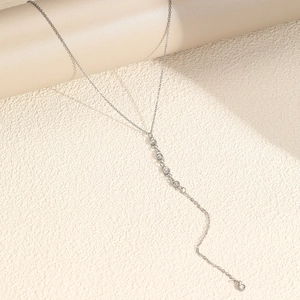 Silver stainless steel Y-shaped necklace with dangling bezel-set zircons on an O-chain
