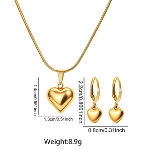 Detailed view of golden heart pendant necklace and hoop earrings set with dimensions