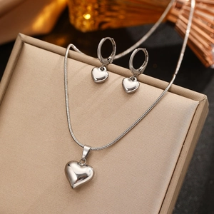 Polished heart pendant necklace and earrings set in silver stainless steel finish