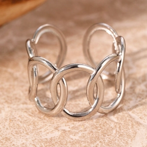 Detail of silver chain-link open ring showing interlocking rings on marble surface