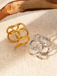 Detailed view of hollow multi-layered gold and silver wide band rings on stone