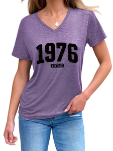 Detail of V-neckline and vintage 1976 print on soft purple short sleeve cotton t-shirt