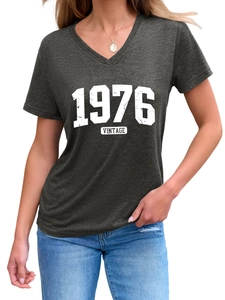 Detail of 1976 Vintage print on charcoal grey V-neck T-shirt with fabric texture