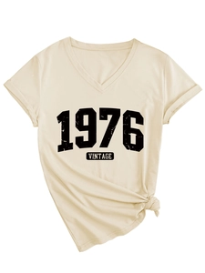 Detail of V-neck beige t-shirt featuring 1976 vintage graphic and side knot design