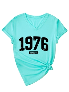 Detail of vintage 1976 V-neck T-shirt with knotted hem and rolled cuff design