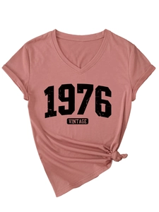 Detail of V-neck dusty rose t-shirt with 1976 vintage print and side knot detail