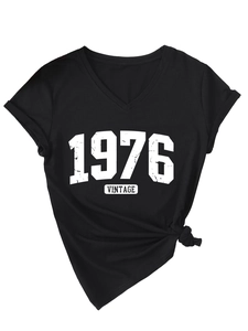 Detail of V-neck black T-shirt featuring vintage 1976 print and stylish side knot design