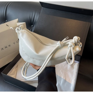 White semi-moon leather bag inside a luxury gift box with dust bag and knot detail