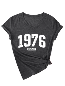 Detail of 1976 vintage V-neck tee featuring rolled sleeves and a knotted side hem