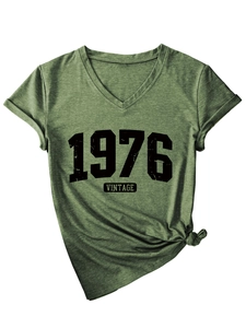 Close-up of army green V-neck T-shirt featuring 1976 vintage print and front knot detail