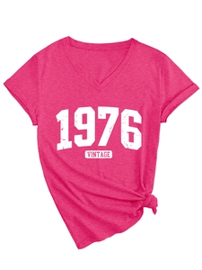 Detail of rose red V-neck T-shirt showing 1976 vintage print and stylish knotted hem design