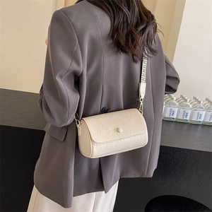 Beige cylinder shoulder bag with textured leather and geometric wide strap for women