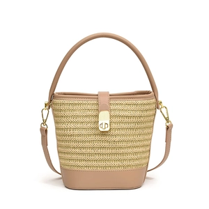 Handwoven straw bucket bag with brown leather trim and golden twist lock for summer