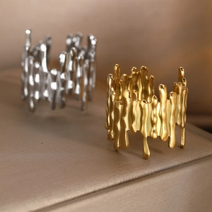 Macro detail of high-polish gold and silver dripping lava style open band rings