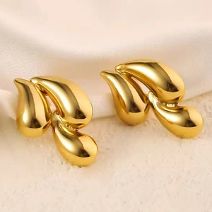 Elegant gold teardrop earrings with a polished mirror finish and flowing liquid design