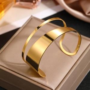 Polished 18K gold stainless steel open bangle with a hollow double-line geometric design