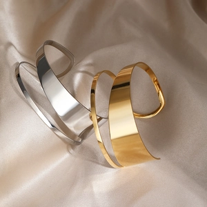 Minimalist wide open cuff bracelets in gold and silver finish on silk fabric