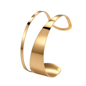 Detail of a 18K gold-plated stainless steel wide cuff bracelet with geometric hollow design