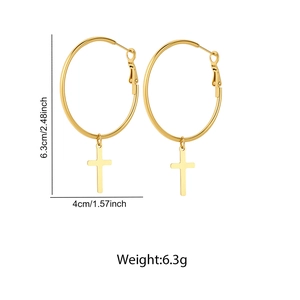 Detailed view of large gold hoop earrings with cross charms and size measurements
