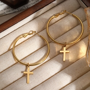 Gothic style 18k gold plated stainless steel cross hoop earrings on velvet jewelry box