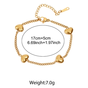 Detailed view of a gold heart charm bracelet showing 17cm length and 5cm extension chain