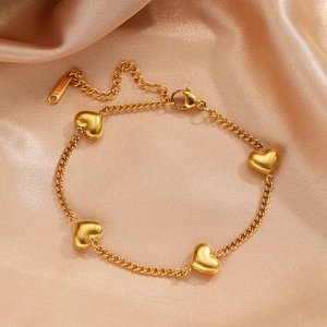 Polished gold stainless steel chain bracelet with four chunky 3D heart charms