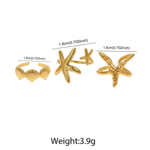 Detailed view of golden starfish and scallop shell rings set with size measurements