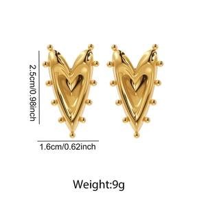 Detail view of gold heart stud earrings with beaded edges measuring 2.5cm by 1.6cm