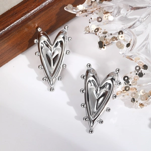 Polished silver stainless steel heart stud earrings with unique textured ball edges for women