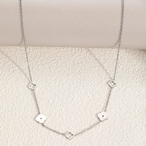 Silver stainless steel necklace featuring open and solid lucky four-leaf clover charms