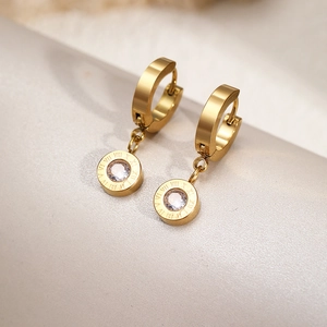 Macro shot of gold-plated stainless steel earrings with Roman numerals and cubic zirconia