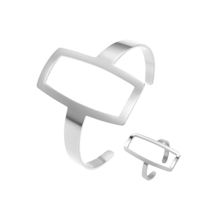Macro view of minimalist silver hollow rectangular open cuff bracelet and ring set