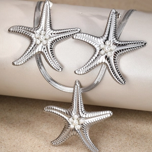 Elegant silver starfish jewelry set with pearls and snake chain on a sandy background