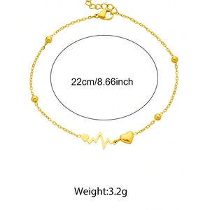 Detail of gold heart and EKG wave anklet with small beads and lobster clasp closure