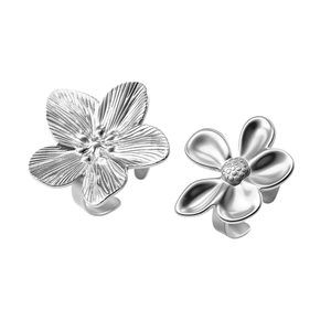 Detail of silver floral rings featuring textured petals and adjustable open bands
