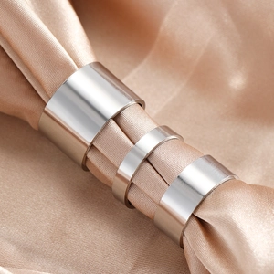 Polished stainless steel adjustable ring set on silk fabric in a minimalist hip-hop style