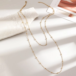 Detailed view of double-layered 18K gold satellite chain with lobster clasp and extension